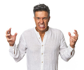 Middle-aged Latino man screaming with rage.