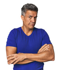 Middle-aged Latino man suspicious, uncertain, examining you.