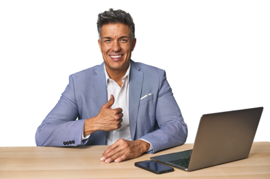 Elegant businessman at desk with laptop smiling and raising thumb up