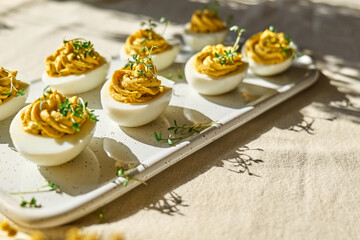 Easter breakfast idea. Stuffed easter eggs mimosa with egg yolk, turmeric, cream cheese and cress...