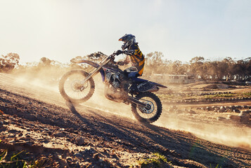 Hill, race and man on dirt bike in desert with adventure, adrenaline and speed in competition, Extreme sport, dust and athlete on off road motorcycle for challenge, power or danger on action course - obrazy, fototapety, plakaty