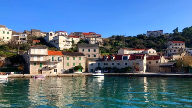 Seaside village. Sleepy seaside town on the Adriatic coast. Harbor and stone buildings in the beautiful town of Povlja, Brac Island, Croatia. Europe.