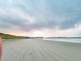 Fototapeta na wymiar Dramatic clouds above Narin Strand, a beautiful large blue flag beach in Portnoo, County Donegal - Ireland.