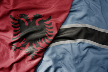 big waving national colorful flag of botswana and national flag of albania .