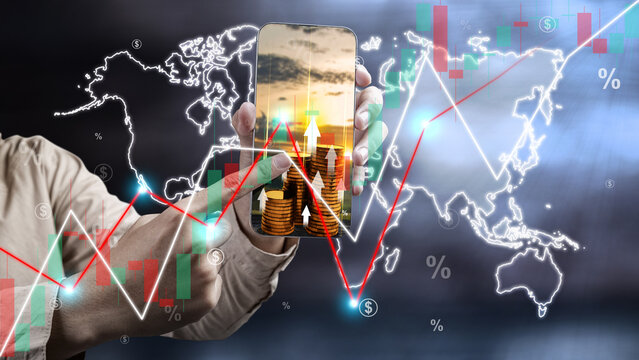 Close up male hand showing and pointing mobile phone with growing stock chart on world map background.