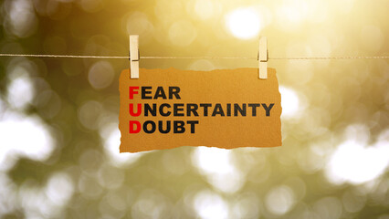 Paper hanging on the rope with 'Fear Uncertainty Doubt' text
