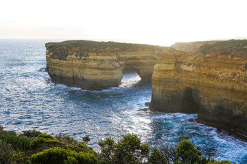 Fototapeta premium Offshore natural arch of Mutton Bird Island seen from the Loch Ard Gorge in the Twelve Apostles Marine National Park along the Great Ocean Road in Victoria, Australia