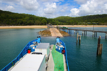 Kingfisher Bay ferry arriving on Fraser Island (K'gari) with passengers and vehicles in Queensland,...