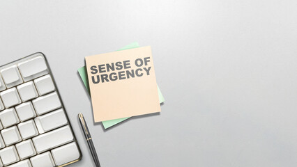 Stack of notepaper with 'sense of urgency' text