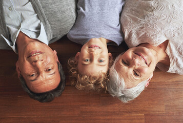 Portrait, grandparents and boy on the floor, love and bonding together with joy or apartment. Family, face or old man with elderly woman, kid or grandchild with fun or cheerful with home or vacation - obrazy, fototapety, plakaty