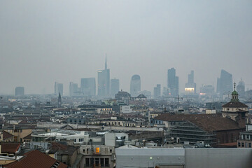 Milan - February 2024 - Milan modern city skyline in smog fog - High Levels air pollution - Day