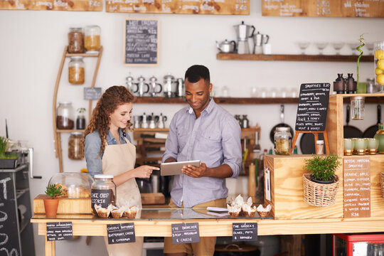 Collaboration, Small Business Shop And Tablet With Owner In Coffee Shop Together For Planning Or Service. Teamwork, Technology For Ecommerce Or Online Order With Man And Woman In Cafe Or Restaurant