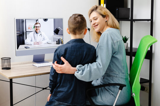 Young mother and child enjoying digital era, having online telemedicine consultation with remote doctor by professional paediatrician about cold and flu virus treatment