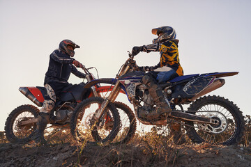 Sport, racer or people on motorcycle outdoor on dirt road with relax after driving, challenge or competition. Motocross, motorbike or dirtbike driver with helmet on offroad course or path for racing