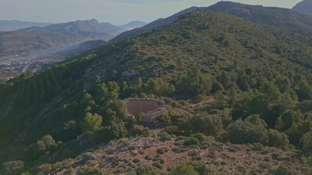 Aerial view looking at a nevera (snow pit) these snow pits were used in antiquity to preserve the fallen snow, Cava Don Miguel, Mariola mountain, Alicante, Spain - stock video