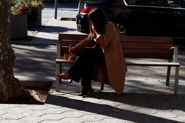Woman sat on a bench