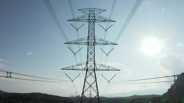 Transmission tower in aerial view. May called electricity pylon, steel utility pole consist of steel structure framing to support carry high-voltage cable or overhead power line for electrical grid.