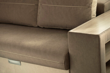 Interior sofa. A soft, comfortable lounge sofa made of cocoa beige velor fabric with a square...