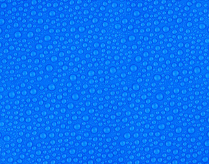 many small water drops on a blue surface