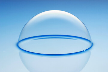 a large soap bubble on light blue water