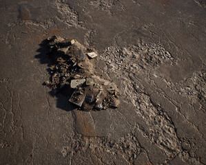 Pile of rubble on an old cracked tarmac surface. - 742708197