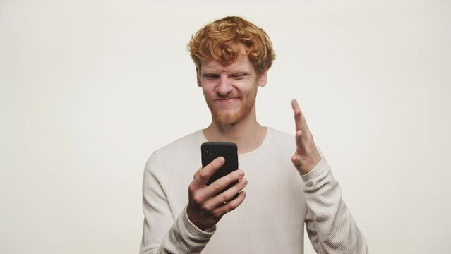Winking Man with Smartphone Making So-So Gesture