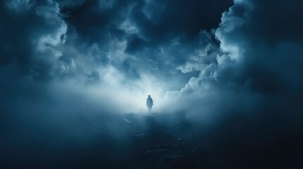 A man standing on top of a mountain under a cloudy sky. Perfect for outdoor adventure or...