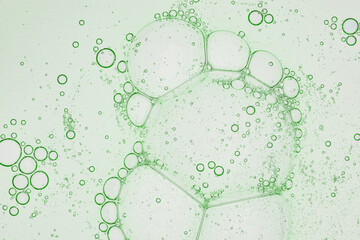 macro photography of air bubbles in liquid green tone background