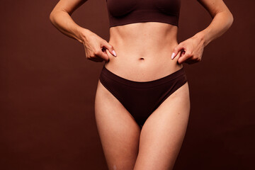 Cropped photo no retouch of lovely young lady clamp belly stomach folds wear trendy lingerie...