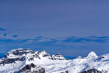 Naklejka premium Scenic view of mountain panorama with snow covered mountain peaks in the Swiss Alps at mount Titlis on a sunny winter day. Photo taken February 21st, 2024, Titlis, Engelberg, Switzerland.