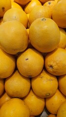 Close up pile of tasty fresh oranges sold at the market as a background.