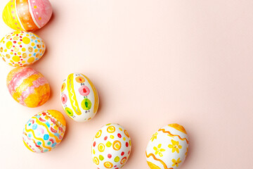 Easter background. Handmade painted eggs lie on a pink background. - 742750311