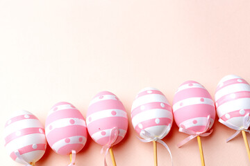 Easter background. Handmade painted eggs lie on a pink background. - 742750535