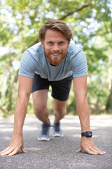 fitness man plank workout training in park outdoors