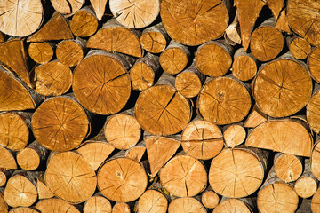 Natural wooden background - closeup of chopped firewood.