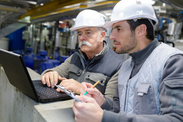 senior site manager checking planning on computer