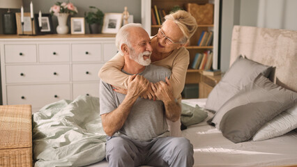 Embraced senior couple in bed
