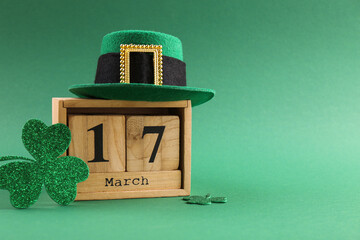 St. Patrick's day - 17th of March. Wooden block calendar, leprechaun hat and decorative clover...
