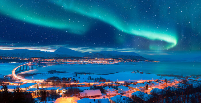 Aurora borealis or Northern lights in the sky over Tromso with Sandnessundet Bridge - Tromso, Norway