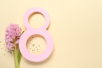 8th of March greeting card design with paper number eight, beautiful flowers and space for text on beige background, flat lay. International Women's day