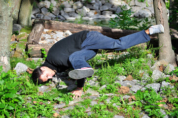 A young acrobatic dancer dances in nature