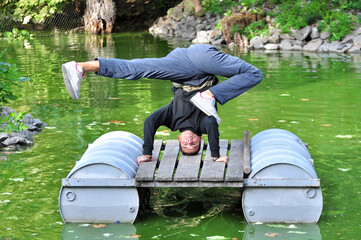 A young acrobatic dancer dances in nature