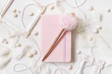 Pink notebook, decorative fur pen and romantic decor on white close up, textbook mockup