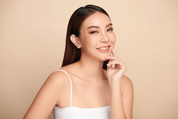 Beautiful young asian woman with clean fresh skin on beige background, Face care, Facial treatment, Cosmetology, beauty and spa, Asian women portrait.