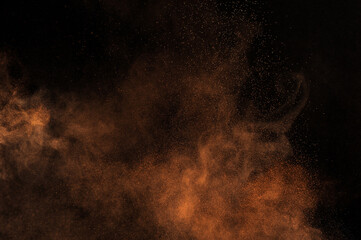 Orange powder explosion on black background. Flame cloud. Yellow dust explode.	
