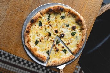 Appetizing Italian cheese pizza. A slice of pizza with a mix of cheeses.