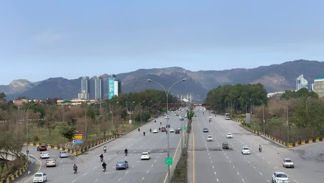 Islamabad highway traffic flowing on the road, view of green mountains, Centaurus mall. Islamabad Pakistan February 02 2024.