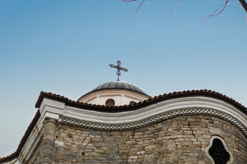 Old brick building on the background of blue sky. View from the bottom up of the Church of Saints Constantine and Helena in the medieval town of Veliko Tarnovo, Bulgaria. Concept of tourism and travel