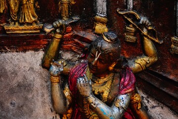 statue of god krishna with four hands