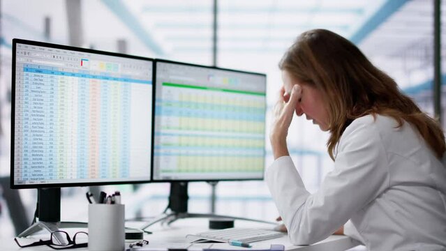 Unhappy Medical Doctor Doing Spreadsheet Codes